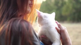 4K Video : Woman were holding a  white cat on her arm in the morning