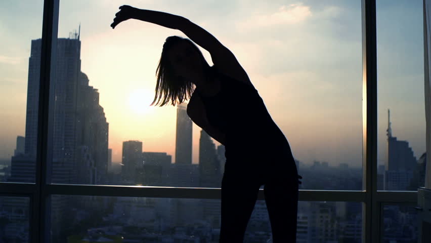 Silhouette of woman exercising bend by window during sunset at home
 | Shutterstock HD Video #23524522