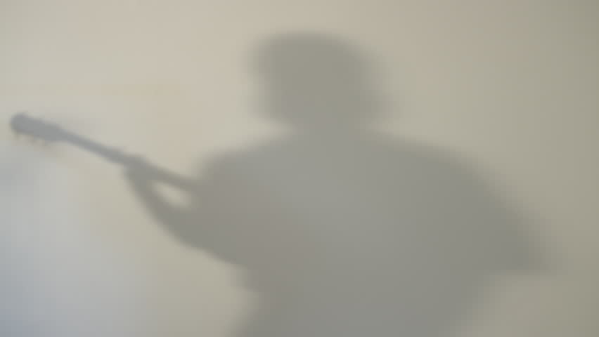 shadow of a singing man on a wall
