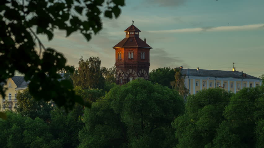 Look at the tower in the summer through the trees and clouds.timelapse