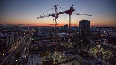 Timelapse of a large construction site as the sun rises over Los Angeles, California.