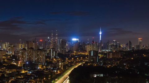 Time lapse of sunrise of the Kuala Lumpur cityscape skyline with a freeway of Kuala Lumpur, Malaysia from night to day, Ultra HD, 4K resolution, Zoom Out Camera Motion