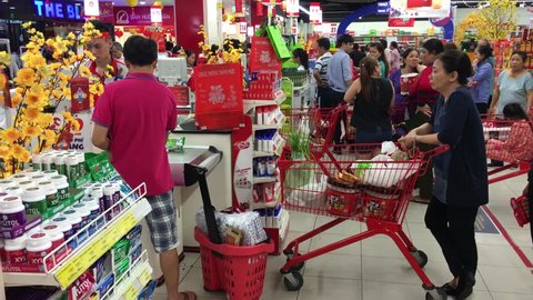 VUNG TAU, VIETNAM - JANUARY 25, 2017: A lot of people stand in line to pay desks in the Lottermart supermarket on Tet Eve.