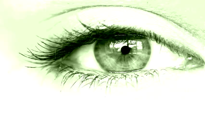 women's eye close up looking around green tinted