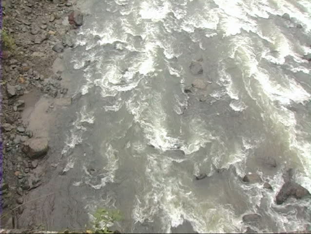 Raging rivulet joins the mighty  Brahmaputra river