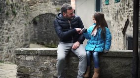 Video of father and daughter talking and playing in an old little village in Italy, 4K