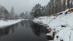 Winter river and forest. Bend of the river. Aerial video. 
