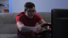 Man playing in the race with wheel sitting on couch