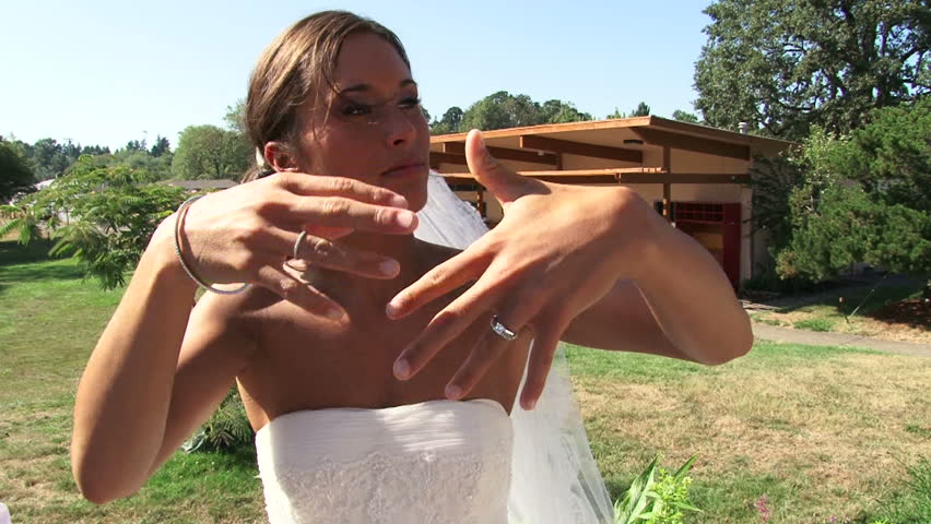Bride shows off her wedding ring.