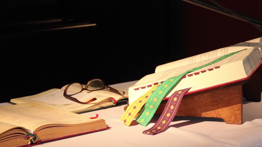 Holy bible, book and glasses on the table in church