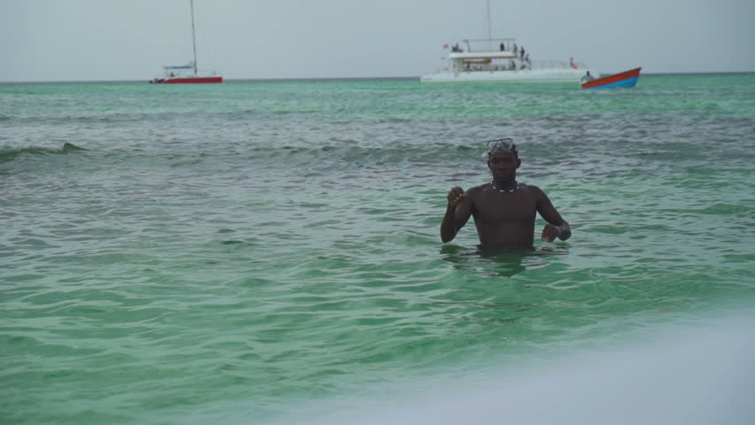 Black man smiling diver going to dive into the ocean