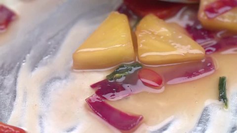 MACRO FOOD: Chef stirs a vegetable dish in a pan