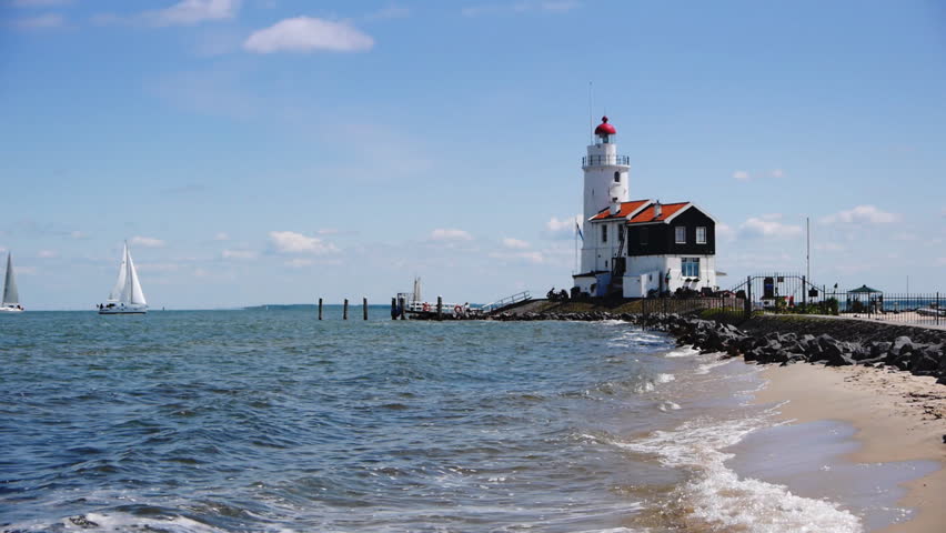 This lighthouse is located in Marken in the Netherlands. A sailing boat is