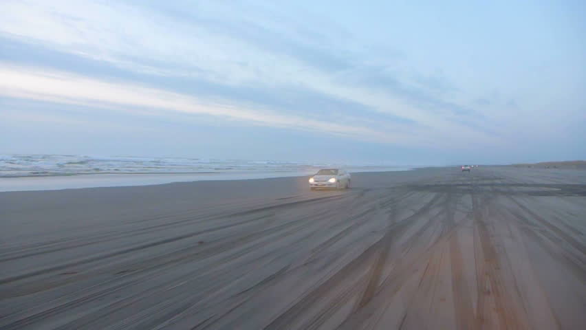 Cars driving on sandy beach next to the Pacific Ocean in Long Beach Washington