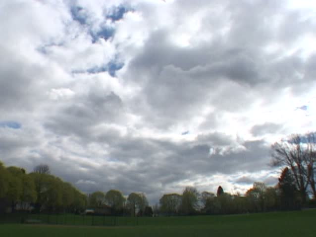 Great clouds during day at Portland Park while people gather for baseball
