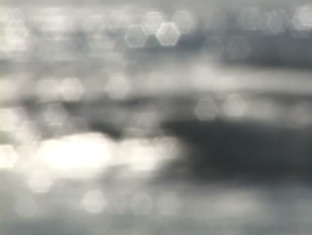 Background texture of waves in ocean reflecting with soft focus.