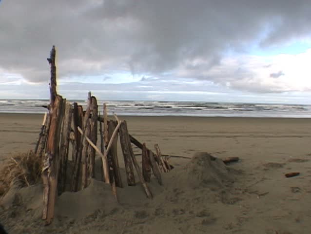 Seaside, Oregon - driftwood fort on sand in front of Pacific Ocean and clouds