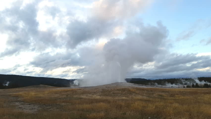 Old faithful geyser erupting, at yellowstone national park, in Wyoming, United states of America