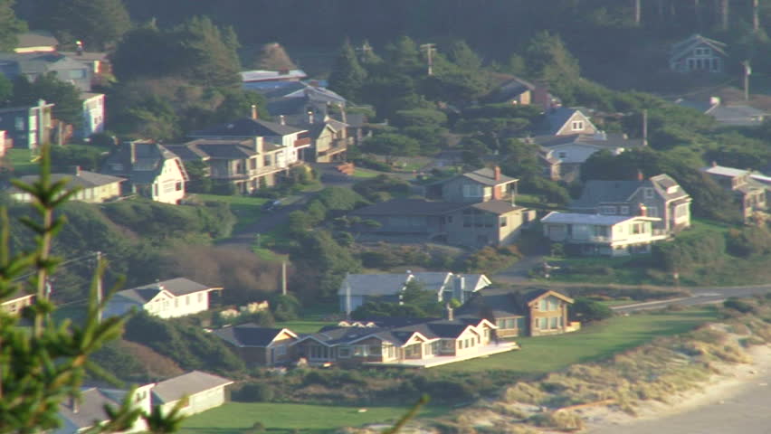 Camera pan, high angle showing beach house community in Oregon.