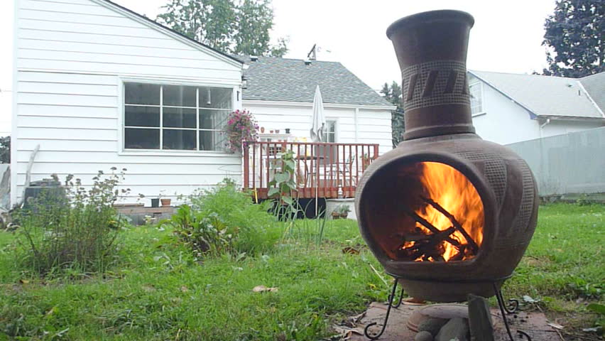 Man starts fire in backyard time lapse.