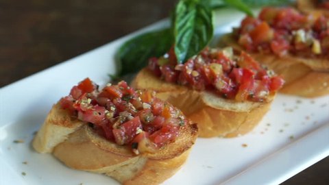 Antipasto Bruschetta, baguette slices topped with tomatoes basil mixed sauce