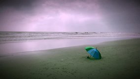 abandon umbrella laying at beach 