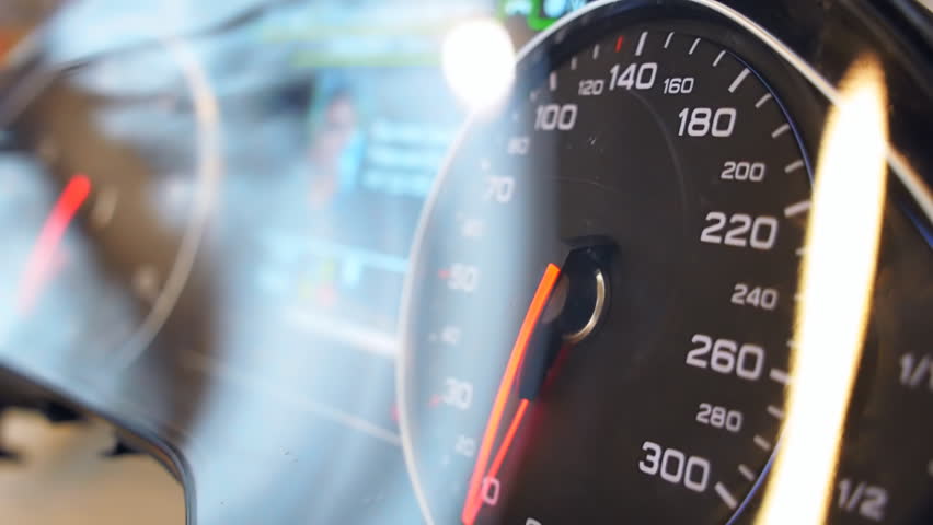 Car speedometer needle is rapidly approaching to the maximum value 300 km/h. Vehicle vibration adds adrenaline and increases the feeling of a strong acceleration. The tachometer needle moves quickly Royalty-Free Stock Footage #23601370