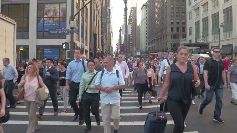 NEW YORK, USA - SEPTEMBER 28: HYPERLAPSE. Busy crowded New York City streets during the rush hour. People, tourists and commuters waiting on pedestrian crossing for green signal to cross the road