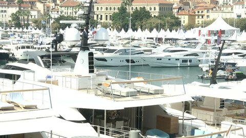 Yachts docked in a big marina during a boat show
