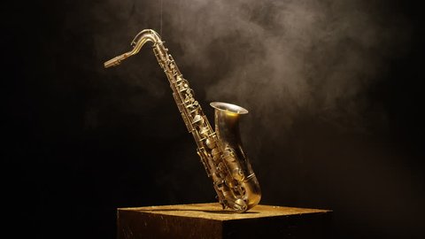 Close-up shot of a beautiful saxophone on black background. Shot on RED HELIUM Cinema Camera in slow motion. 4K