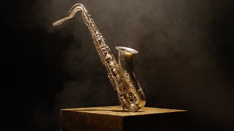 Close-up shot of a beautiful saxophone on black background. Shot on RED HELIUM Cinema Camera in slow motion. 