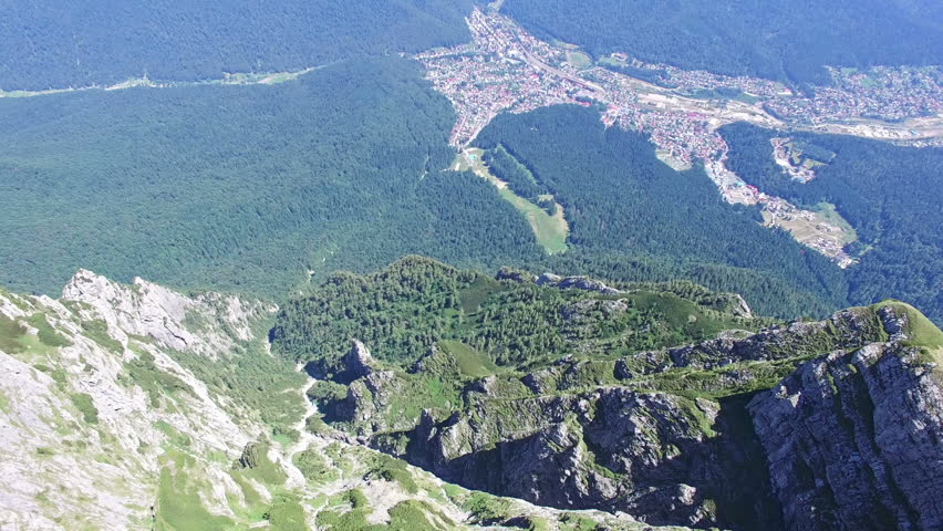 Caraiman Peak, aerial tilt to Bucegi city, Romania