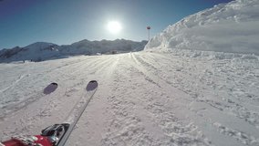 4k skiing footage, skiers view of skis and ski slope on sunny winter day
