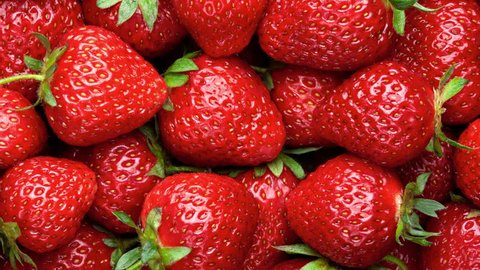Strawberry background.  Red ripe organic strawberries on market counter. UHD, 4K