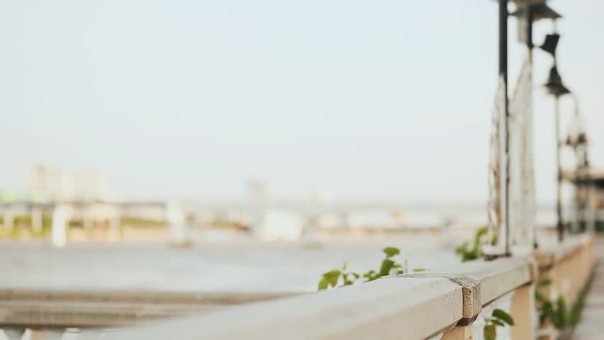 Vietnam girl in the national red dress Ao Dai posing and smiling for the camera on the seafront