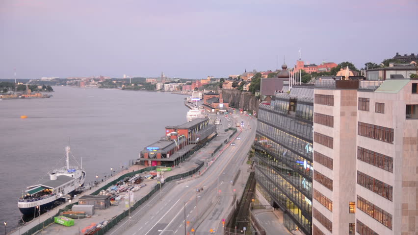 Waterfront city street and hotel building in Stockholm, Sweden at dusk