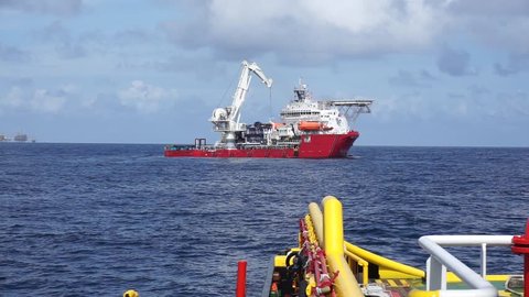 Offshore vessel recover pipe spool in the sub sea during gas pipeline installation project at Sarawak Operation, South China Sea,Malaysia.