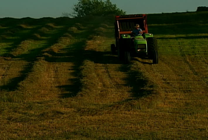 Farmer baling hay