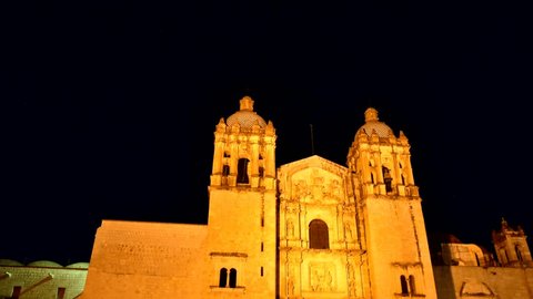 Oaxaca, cherch Santo Domingo, bell towers, church of passage from day to night with lights that light up, stars of the night sky,   time lapse  