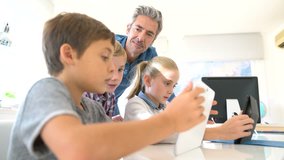 Kids in classroom learning with digital tablet