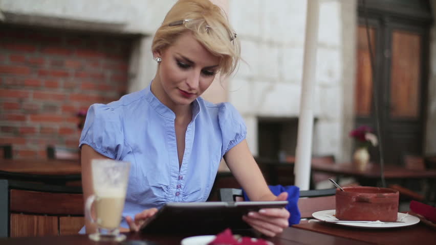 Young businesswoman working on tablet computer in cafe | Shutterstock HD Video #2364428