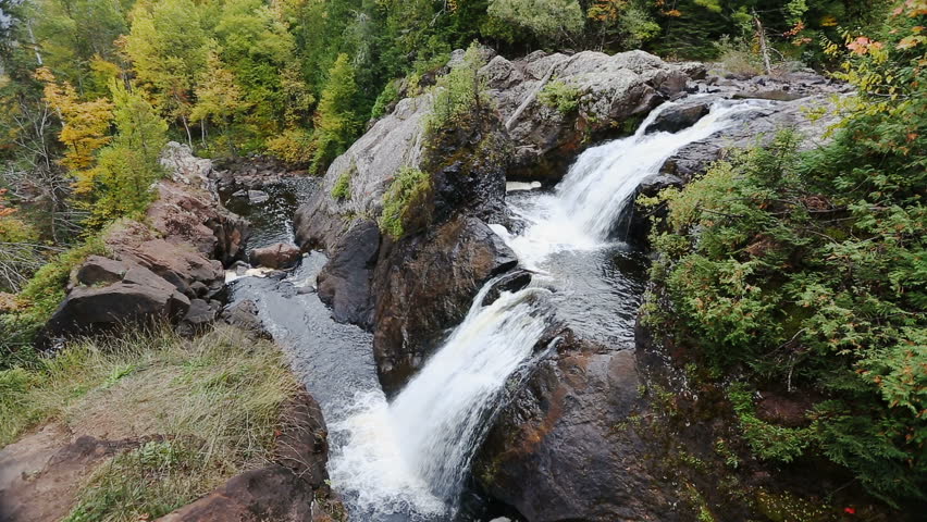 Gabbro Falls is a tiered waterfall plunging over a basalt rock cliff on the Black River of Michigan