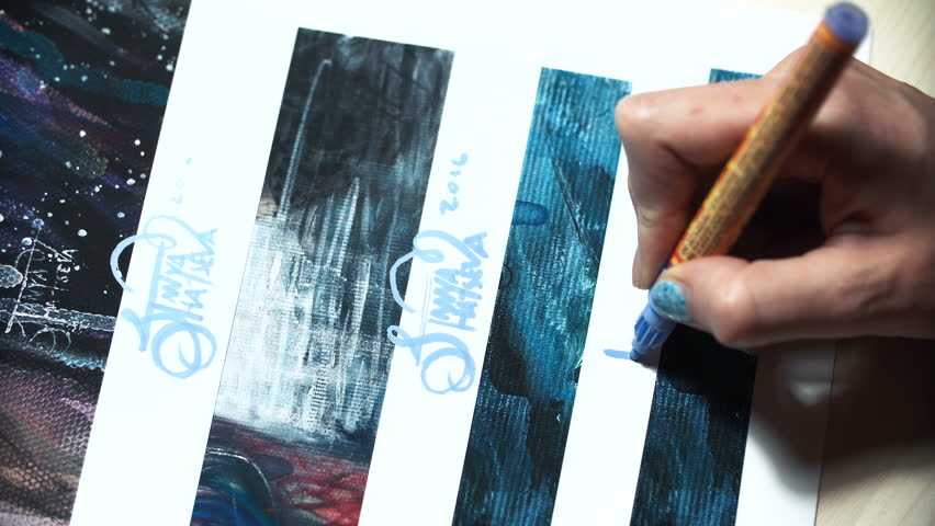 Girl artist signs some of his works. Painted sign of a master. Signature print on a blue felt-tip marker.