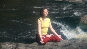 Tranquil girl practicing yoga enjoying the energy of nature