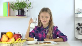 4K Child Drinking Milk at Breakfast, Girl Eating Bread and Chocolate in Kitchen 