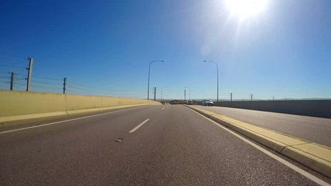 4k country freeway vehicle POV, driving along the Northern Expressway, from Adelaide, South Australia to the Barossa Valley, with early morning lens flare, timelapse. 