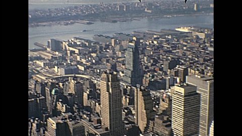 New York, United States of America - circa 1970: Vintage aerial view panorama from top of Empire State Building, with Top of The Rock, Rockefeller Center, Central Park and city traffic.