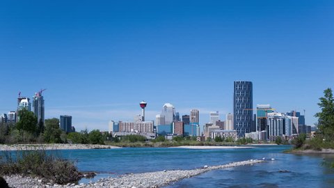 4K Time lapse zoom in of Calgary Skyline at daytime with Bow river in foreground