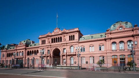 BUENOS AIRES, ARGENTINA - JAN 05, 2017: 4K Timelapse zoom out of people walking by Casa Rosada at Plaza de Mayo square. The historic landmark is presidential office and federal government building.