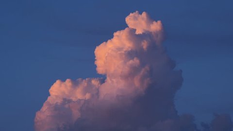 4K Time lapse close up of a red illuminated cloud at sunset